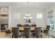 Contemporary dining room with stainless steel fridge, modern light fixture, and horse art at 750 Tannery Cmn, Alpharetta, GA 30009