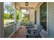Relaxing front porch features brick flooring, hanging lights, and comfortable seating at 750 Tannery Cmn, Alpharetta, GA 30009