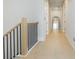 Well-lit hallway featuring hardwood floors and neutral walls, providing a seamless transition between rooms at 750 Tannery Cmn, Alpharetta, GA 30009