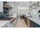 Open-concept kitchen featuring stainless steel appliances, gas range, and a beautiful island with barstool seating at 750 Tannery Cmn, Alpharetta, GA 30009