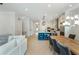 Relaxing living space next to the dining area and kitchen with white cabinets and stainless appliances at 750 Tannery Cmn, Alpharetta, GA 30009