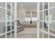 Elegant living room with neutral tones, plush seating, and a light-filled atmosphere through the french doors at 750 Tannery Cmn, Alpharetta, GA 30009