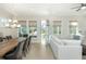 Open-concept living and dining area with hardwood floors, large windows, a neutral color palette and modern lighting at 750 Tannery Cmn, Alpharetta, GA 30009