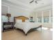 Bright main bedroom with hardwood floors, tray ceiling, and ample natural light from the large windows at 750 Tannery Cmn, Alpharetta, GA 30009