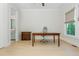 Bright office space featuring a wooden desk, cabinet, and a view to the outside, next to the bathroom at 750 Tannery Cmn, Alpharetta, GA 30009