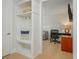 Hallway nook leads into an open office with sleek desk, comfortable gray sofa, and neutral paint at 750 Tannery Cmn, Alpharetta, GA 30009