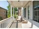 Cozy covered porch with comfortable seating, offering a relaxing outdoor space with a neighborhood view at 750 Tannery Cmn, Alpharetta, GA 30009