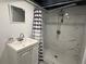 Bathroom features a modern shower with stylish tile, a sink with vanity, and a framed mirror at 2059 Clearwater Se Dr, Marietta, GA 30067
