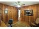 Charming bedroom with wood-paneled walls, ceiling fan and hardwood floors at 2059 Clearwater Se Dr, Marietta, GA 30067