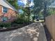 Spacious driveway showcasing the side of the brick home and landscaping at 2059 Clearwater Se Dr, Marietta, GA 30067