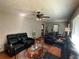 Inviting living room featuring leather furniture and a decorative ceiling fan at 2059 Clearwater Se Dr, Marietta, GA 30067