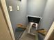 Stairwell with gray walls, wooden handrails and a view into a room at 2059 Clearwater Se Dr, Marietta, GA 30067