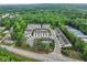 Aerial view of the community featuring townhomes surrounded by trees and greenery near streets and storage units at 218 Piedmont Cir, Canton, GA 30114