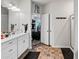 Modern bathroom with double sinks, shower, and view to the Primary bedroom at 218 Piedmont Cir, Canton, GA 30114