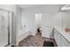 Bright bathroom featuring a bathtub, glass-enclosed shower, and double vanity at 218 Piedmont Cir, Canton, GA 30114