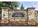 Stone entrance sign reading 'Parkside' welcomes you to this great community, enveloped in trees and foliage at 218 Piedmont Cir, Canton, GA 30114