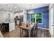 Cozy dining area off the kitchen with natural light, hardwood floors, and stylish light fixture at 218 Piedmont Cir, Canton, GA 30114