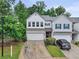 Charming two-story townhome featuring a two-car garage, ample parking, and lush landscaping at 218 Piedmont Cir, Canton, GA 30114