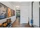 Inviting hallway featuring hardwood floors, unique artwork, and open access to living area at 218 Piedmont Cir, Canton, GA 30114