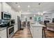 Modern kitchen featuring stainless steel appliances, granite countertops, and open dining area at 218 Piedmont Cir, Canton, GA 30114