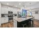 Modern kitchen showcasing an island with bar seating, stainless appliances, and hardwood floors at 218 Piedmont Cir, Canton, GA 30114