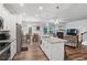 Modern kitchen featuring stainless steel appliances, granite countertops, and open dining area at 218 Piedmont Cir, Canton, GA 30114