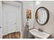 Stylish powder room featuring a modern sink, mirror, and decorative artwork at 218 Piedmont Cir, Canton, GA 30114