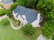 Overhead angle of a home highlighting the roof, backyard, and mature trees surrounding the property at 2552 Berwick Walk, Snellville, GA 30078