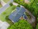 An aerial shot of a home that shows the roof, back deck, driveway, and surrounding trees at 2552 Berwick Walk, Snellville, GA 30078