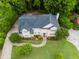 Aerial view of a home showing a well-maintained roof, expansive lawn, and driveway surrounded by lush trees at 2552 Berwick Walk, Snellville, GA 30078