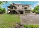 Back exterior view of home with large backyard, deck, and outdoor garage at 2552 Berwick Walk, Snellville, GA 30078