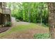Backyard featuring grass, trees, and stairs leading up to a screened-in back porch at 2552 Berwick Walk, Snellville, GA 30078