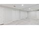Finished basement area featuring light gray floors, large mirror, and double-door closet at 2552 Berwick Walk, Snellville, GA 30078