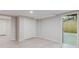 Finished basement space with light gray flooring, double-door closet, and open doorways at 2552 Berwick Walk, Snellville, GA 30078