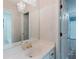 Bathroom with white cabinets, a crystal chandelier, and large vanity mirror at 2552 Berwick Walk, Snellville, GA 30078