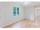 Bright bedroom featuring hardwood floors, white walls, a fan, and a window with natural light at 2552 Berwick Walk, Snellville, GA 30078