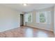 Bright bedroom featuring wood floors, white walls, closet, and windows with natural light at 2552 Berwick Walk, Snellville, GA 30078