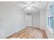 Bedroom with hardwood floors, white walls, a fan, and a window with natural light at 2552 Berwick Walk, Snellville, GA 30078
