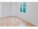 Bedroom with hardwood floors, white walls, closet, and a window with natural light at 2552 Berwick Walk, Snellville, GA 30078