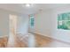 Bright bedroom featuring hardwood floors, white walls, and windows with natural light at 2552 Berwick Walk, Snellville, GA 30078