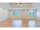 Spacious bedroom featuring beautiful hardwood floors, a ceiling fan, and natural light from the large windows at 2552 Berwick Walk, Snellville, GA 30078