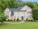 Charming two-story home featuring a manicured lawn, stone accents, and mature trees adding to its curb appeal at 2552 Berwick Walk, Snellville, GA 30078