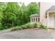 Exterior view of house featuring a white-trimmed sunroom with windows and a wooded area at 2552 Berwick Walk, Snellville, GA 30078