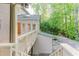 View of the house exterior with a wooden deck and staircase leading to the backyard at 2552 Berwick Walk, Snellville, GA 30078