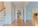 Bright foyer featuring hardwood floors, staircase, and open doorways to other rooms at 2552 Berwick Walk, Snellville, GA 30078