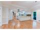 A bright, white kitchen offers modern stainless hood and appliances, tiled backsplash, and hardwood floors at 2552 Berwick Walk, Snellville, GA 30078