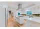 White kitchen features quartz counters, gas cooktop, stainless appliances, mosaic backsplash, and hardwood flooring at 2552 Berwick Walk, Snellville, GA 30078