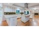 Bright kitchen showcases white cabinetry, quartz countertops, an island gas cooktop, and mosaic tile backsplash at 2552 Berwick Walk, Snellville, GA 30078