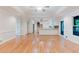 Open-concept kitchen with stainless hood and appliances overlooks hardwood floors with plentiful light and access to the deck at 2552 Berwick Walk, Snellville, GA 30078