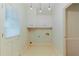 Well-lit laundry room offers built-in storage and ample floor space at 2552 Berwick Walk, Snellville, GA 30078